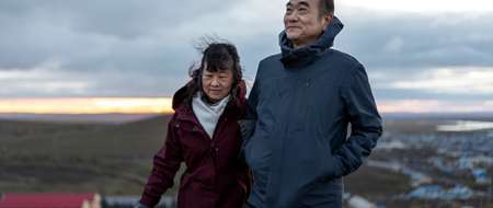 Couple on balcony at sunset