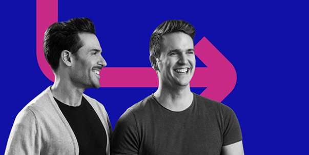 Two young men smiling
